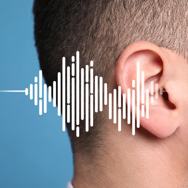 Noise-induced hearing loss concept. Side profile of an ear with sound waves illustration on light blue background.